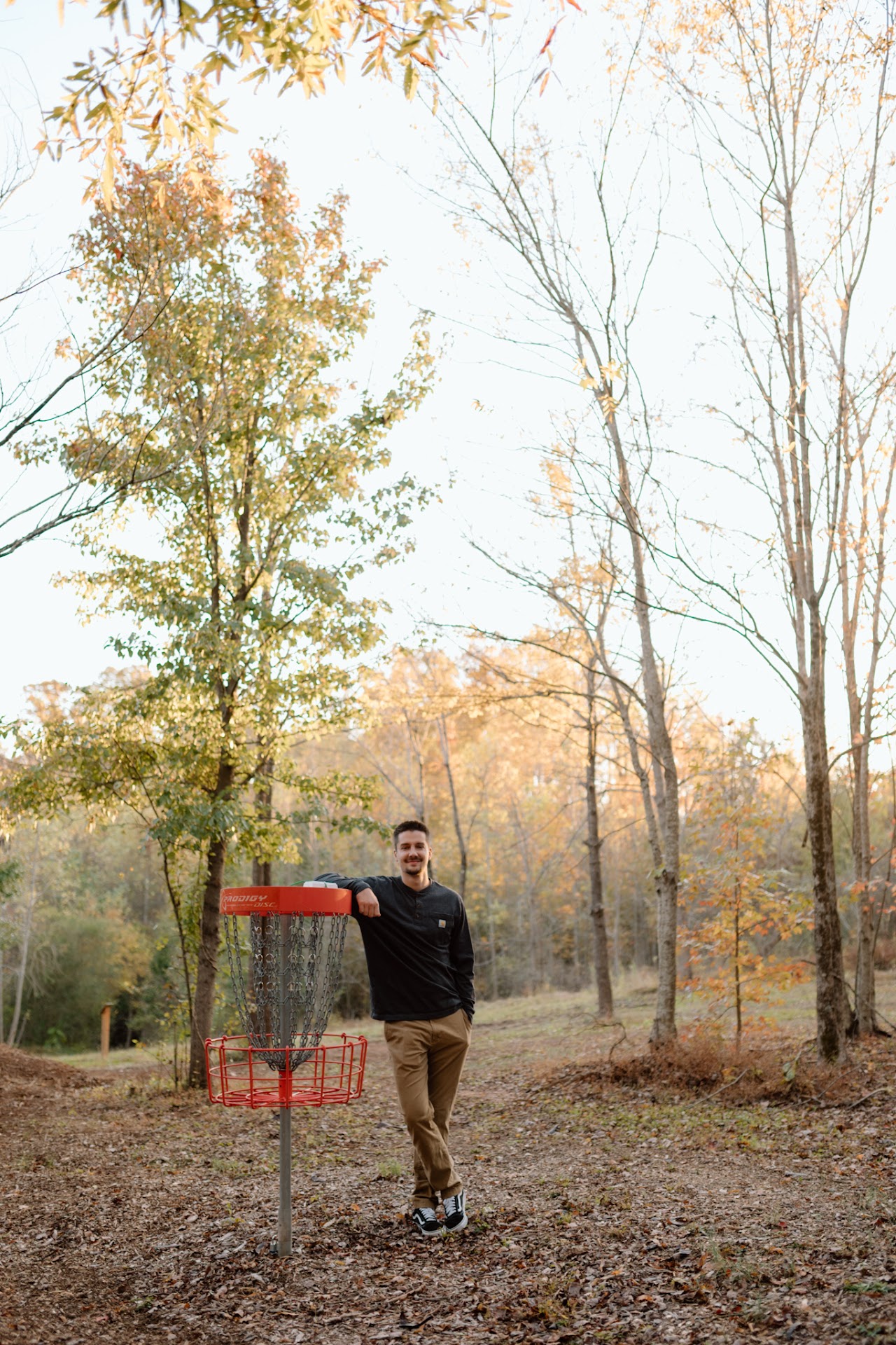 Ben Altmire beside a disc golf basket, a sport that inspired the Circle One name